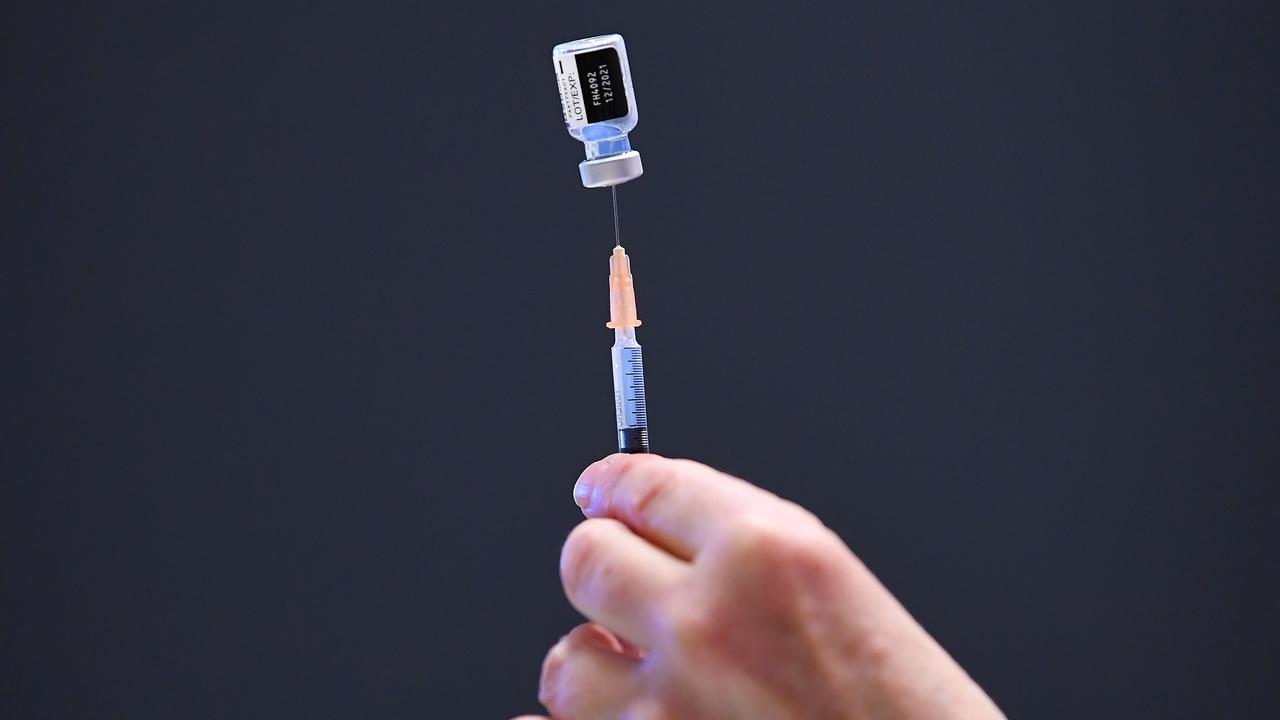 A healthcare worker preps a COVID-19 vaccination dose (file image)