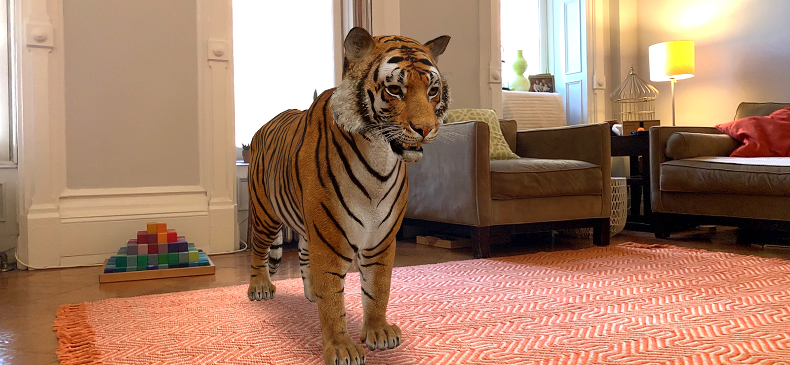 An AR image of a tiger appears to stand in a brightly lit living room decorated with an orange and white geometric-patterned rug and modern leather furniture.