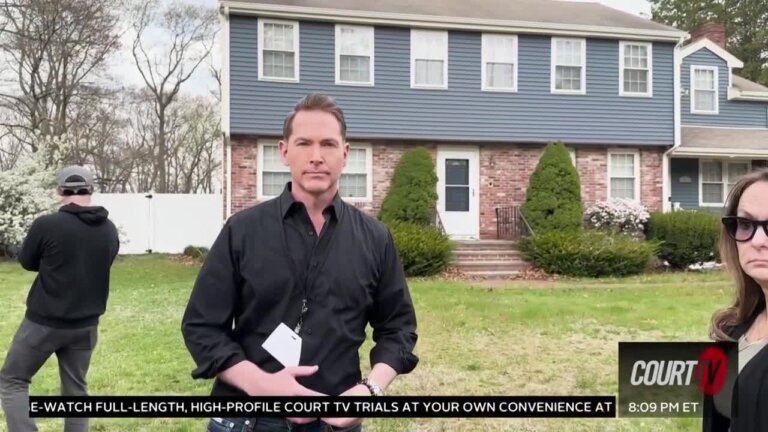 handsome guy stands in front of a suburban house